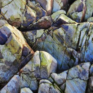 Image shows multi-coloured rock on Whitesands beach Pembrokeshire