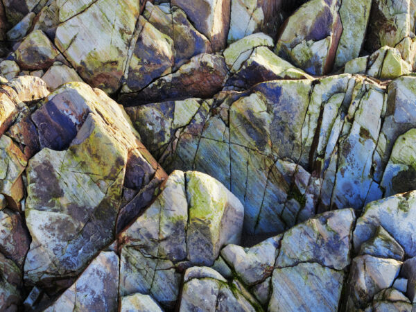 abstract fine art close-up photographic Image of rocks. Yellow, blue, green, purple. Wall art.