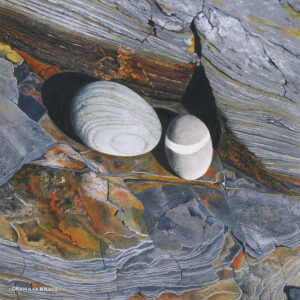 Banded Pebbles on Slate Shelf